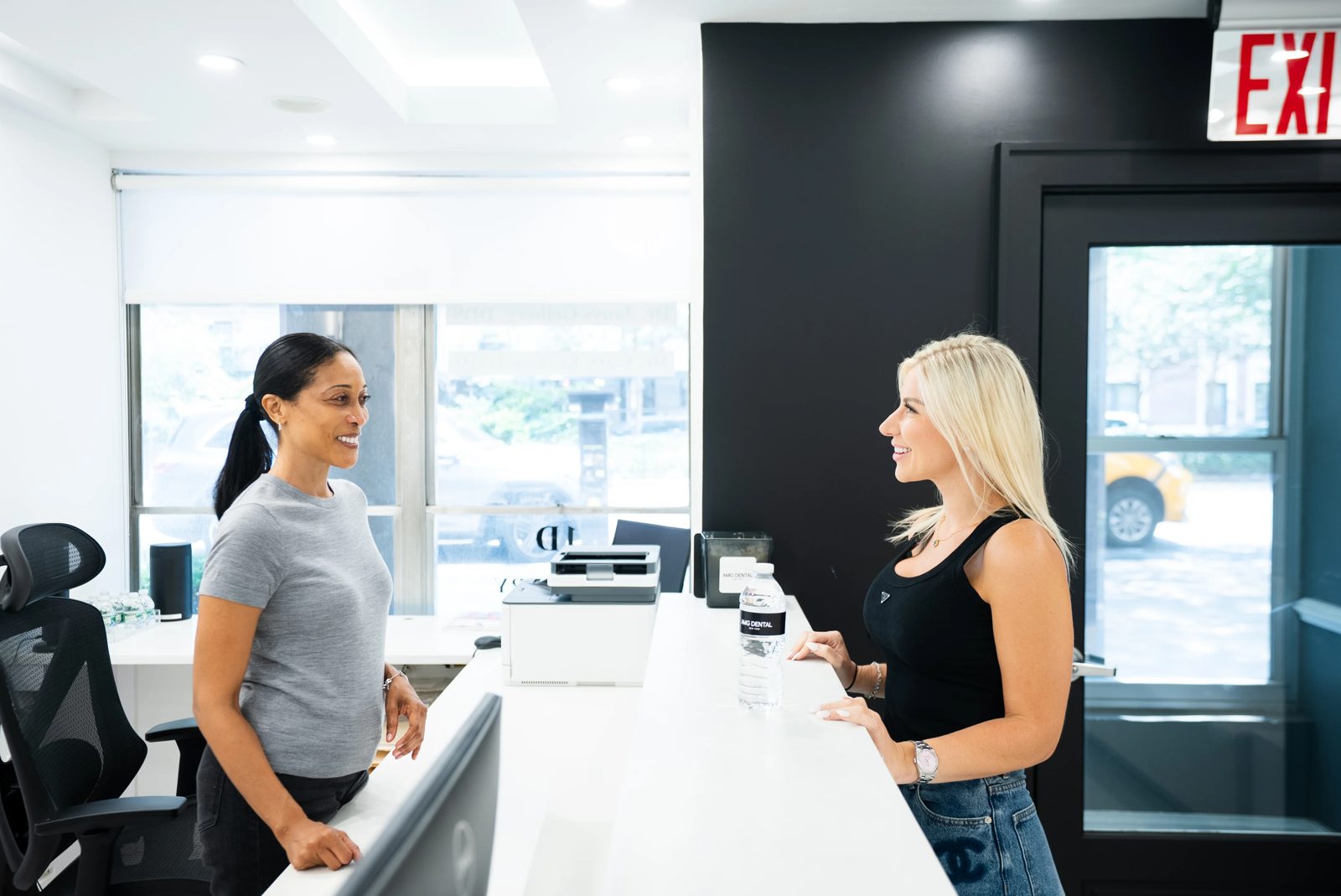 AMG Dental front desk team welcoming a patient
