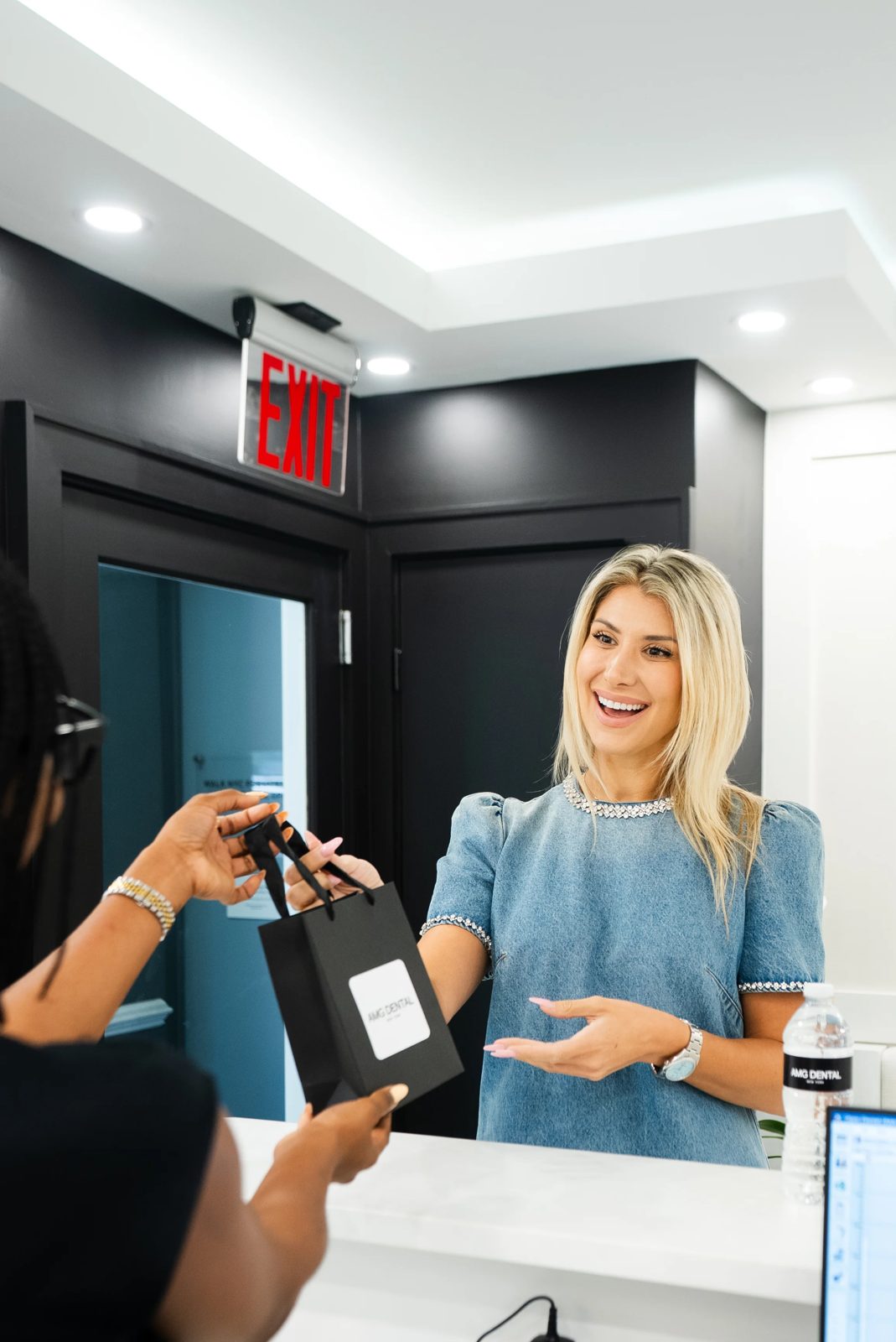 Patient receiving an AMG Dental gift bag at the front desk